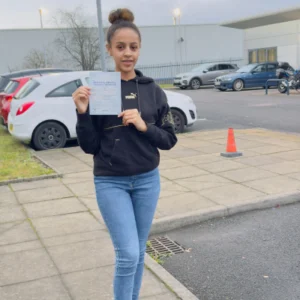 Wiz Driving School first time pass Manchester, student celebrating with certificate