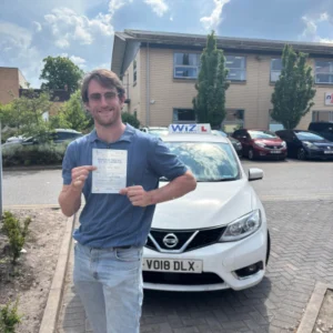 Wiz Driving School Manchester test pass, student holding DVSA pass certificate