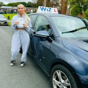 Wiz Driving School Manchester Wall of Fame, student passes driving test with certificate