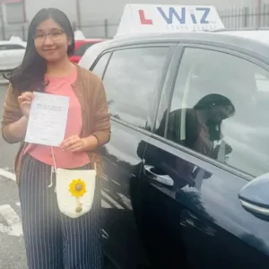 Wiz Driving School Manchester Wall of Fame, student passes driving test with certificate